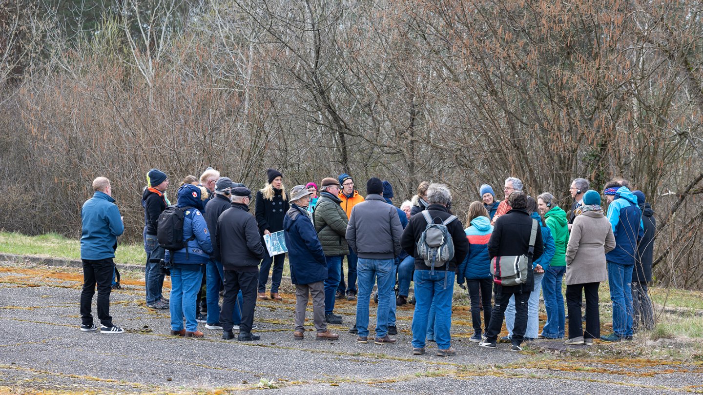 Citizens gather in a circle during the walk on the customs island.