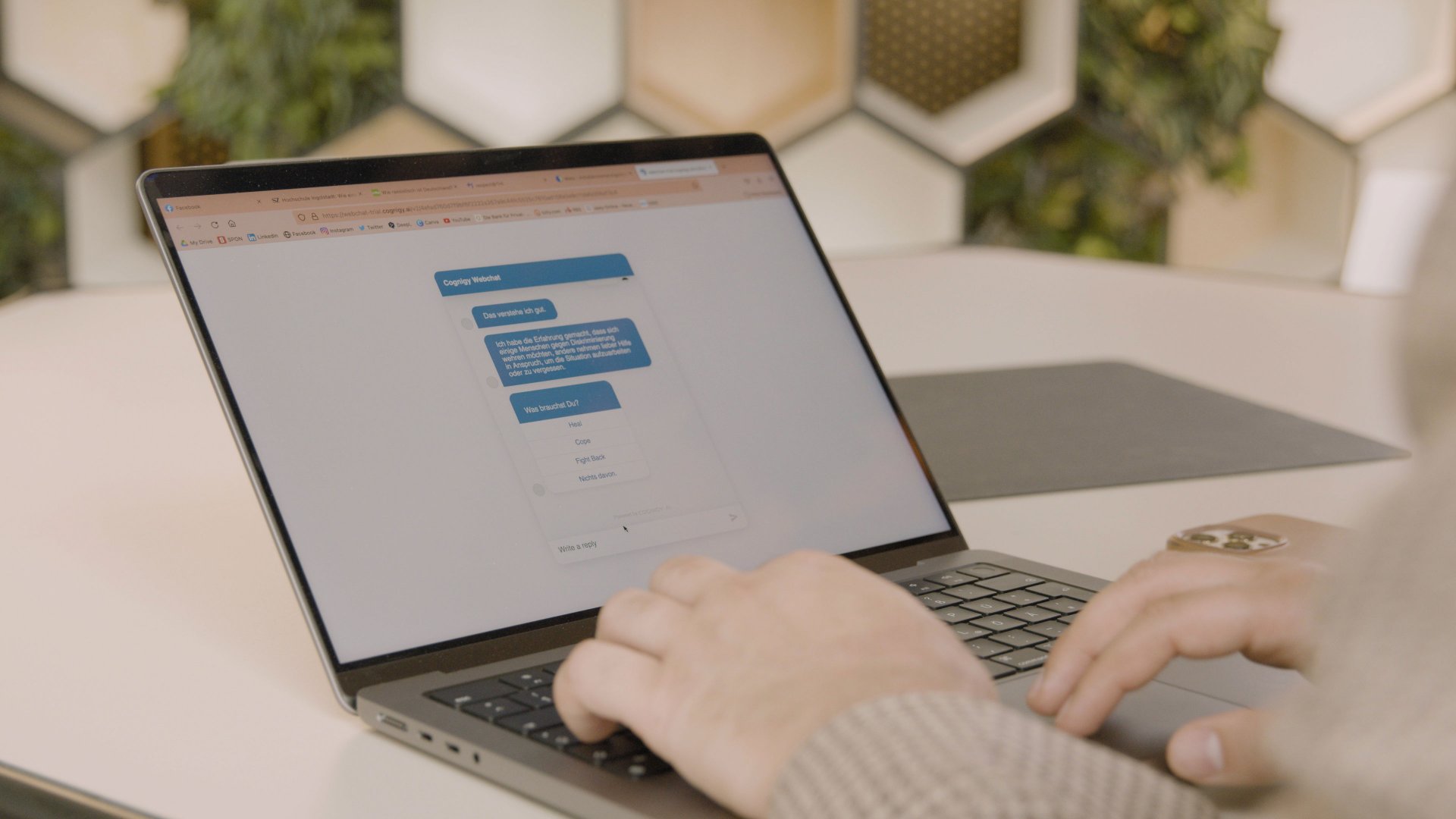 Said Haider schreibt am Laptop mit dem Chatbot