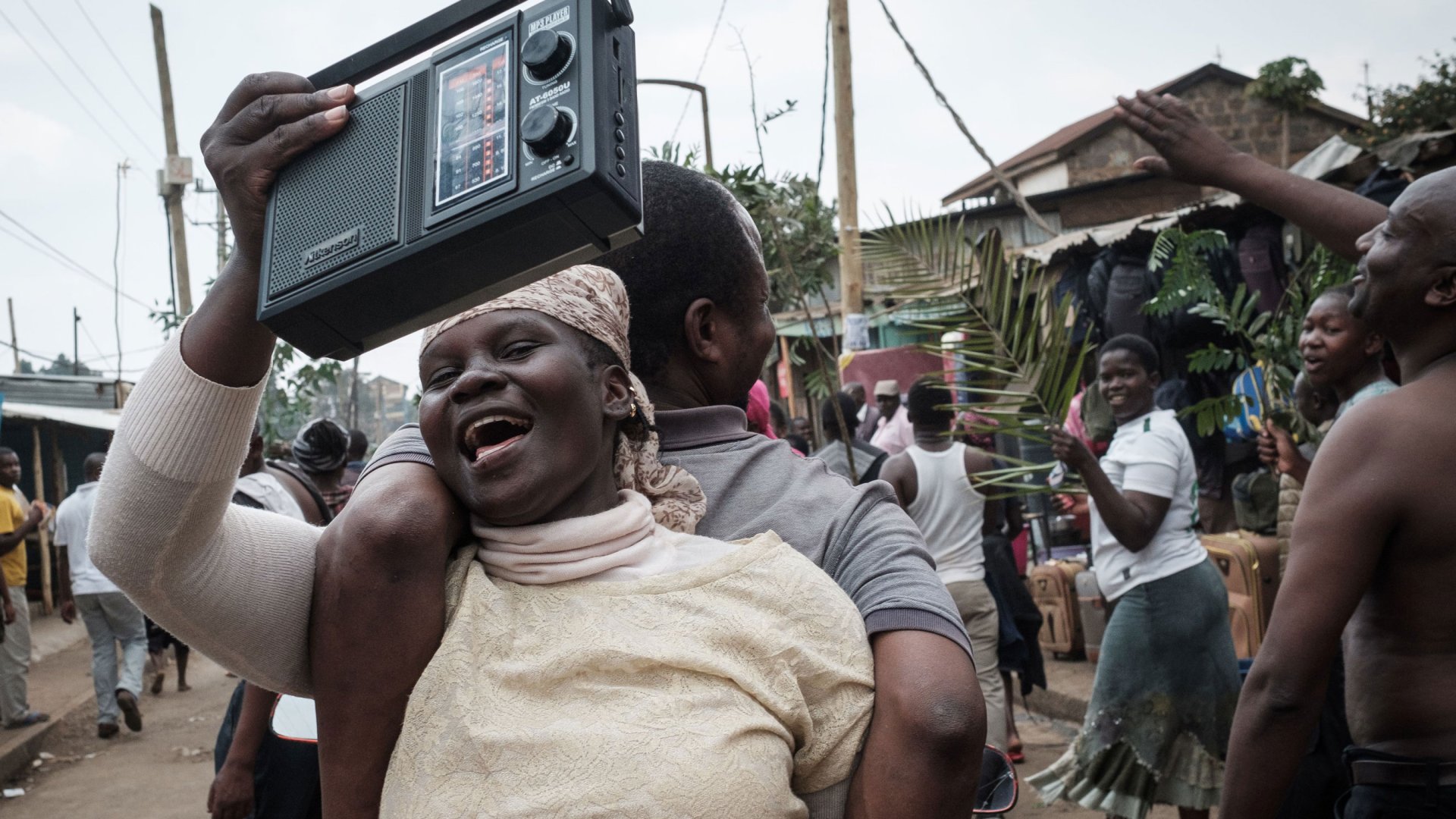 A woman and a man dance back to back to radio music