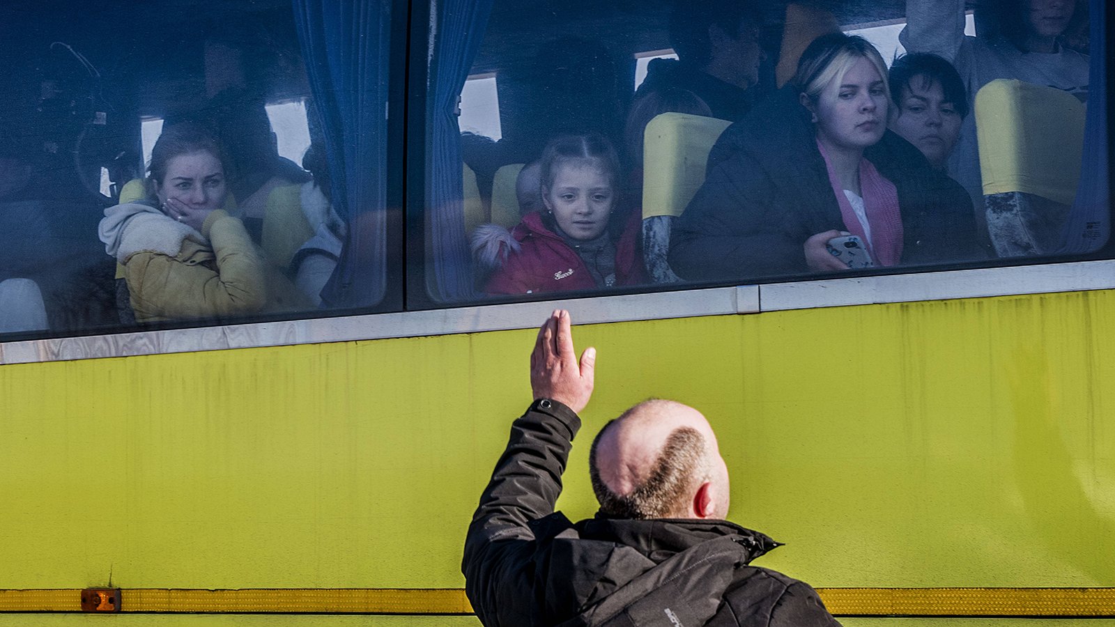 Ukrainian man says goodbye to wife and child on bus