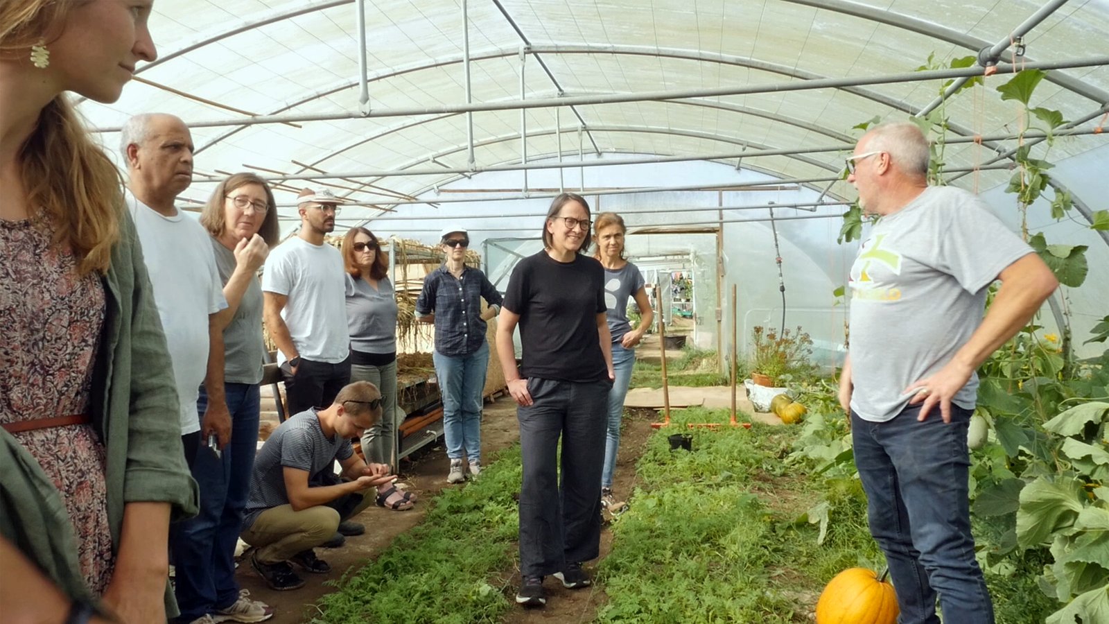 Group listening to lecture in greenhouse