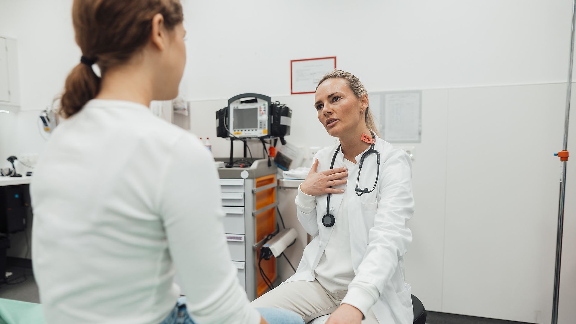 A female doctor talking to a young patient